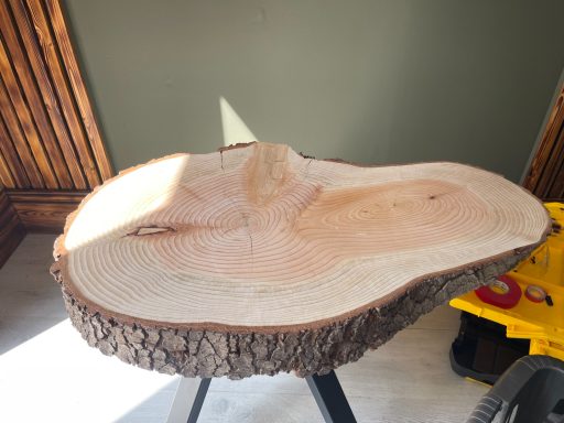 Smooth, natural wood slab with a light finish and distinct grain patterns.