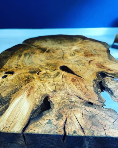 Close-up of a textured wooden surface with intricate grain patterns and natural imperfections.